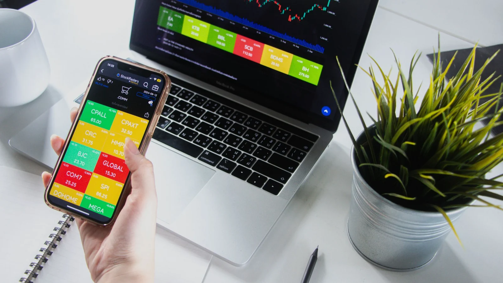 Olymp Trade app on phone and desktop workspace